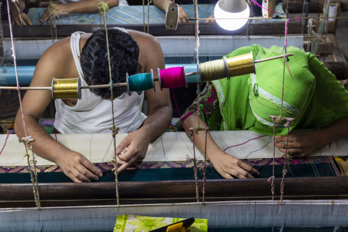 Bangladeshi people weaving in a sari factory, Dhaka Division, Rupganj, Bangladesh