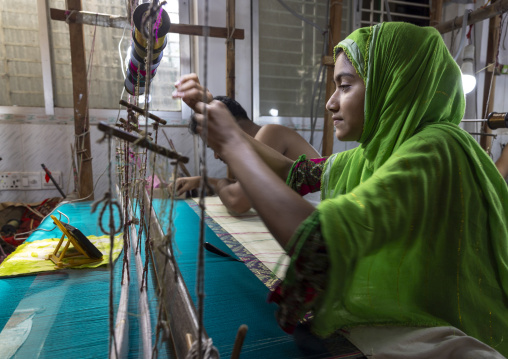 Bangladeshi woman weaving in a sari factory, Dhaka Division, Rupganj, Bangladesh