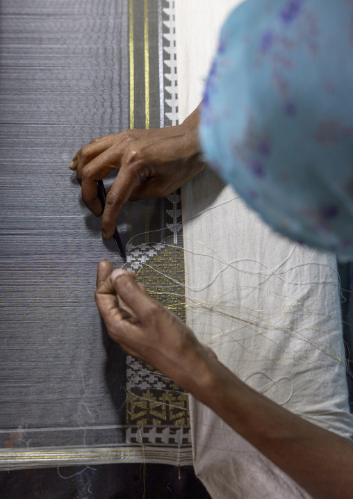 Bangladeshi woman weaving in a sari factory, Dhaka Division, Rupganj, Bangladesh