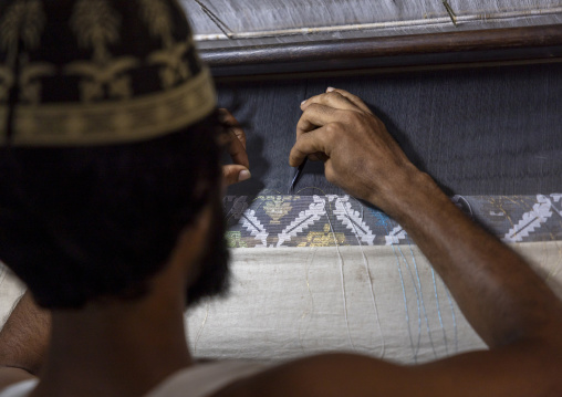 Bangladeshi man weaving in a sari factory, Dhaka Division, Rupganj, Bangladesh