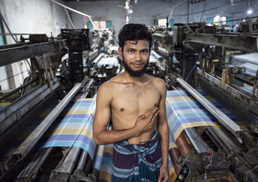 Bangladeshi man working in a extile factory looms, Dhaka Division, Rupganj, Bangladesh