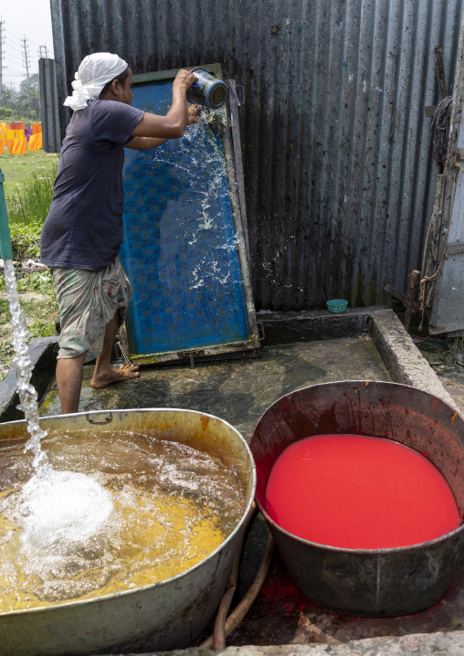 Bangladeshi man washing screen printing tools, Dhaka Division, Rupganj, Bangladesh