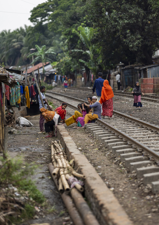 Bangladeshi women looking for lices on child hair on a railway track, Chittagong Division, Chittagong, Bangladesh