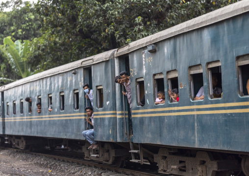 Passengers look out of a train carriage window, Chittagong Division, Chittagong, Bangladesh