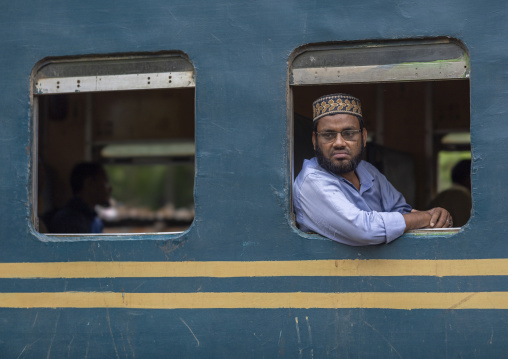 Passenger looks out of a train carriage window, Chittagong Division, Chittagong, Bangladesh