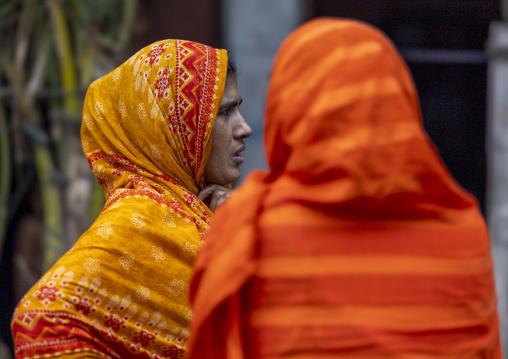 Bangladeshi women with orange saris in the street, Chittagong Division, Chittagong, Bangladesh