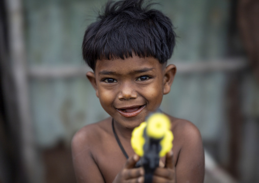 Portrait of a bangladeshi boy with a toy gun, Chittagong Division, Chittagong, Bangladesh