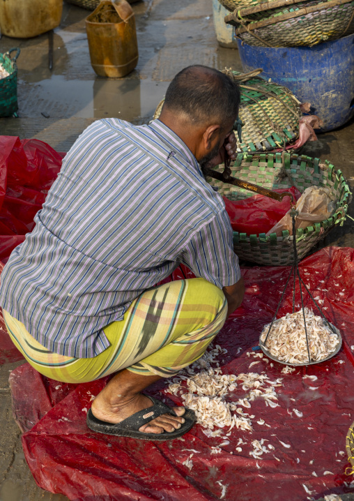 Bangladeshi man selling fishes in fish market, Chittagong Division, Chittagong, Bangladesh