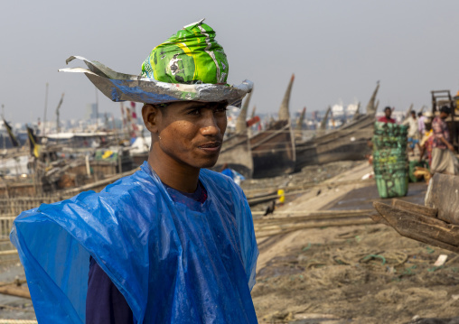 A bangladeshi porter at the morning fish market, Chittagong Division, Chittagong, Bangladesh