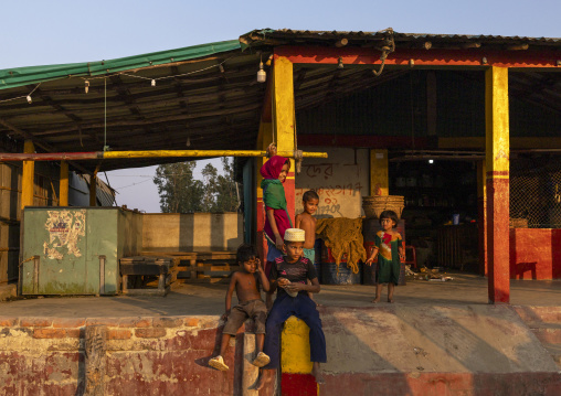 Bangladeshi children in a fishery at sunset, Chittagong Division, Cox's Bazar Sadar, Bangladesh