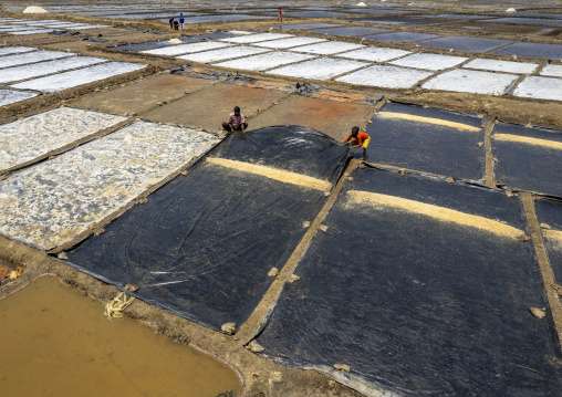 Bangladeshi men working in a salt field, Chittagong Division, Maheshkhali, Bangladesh