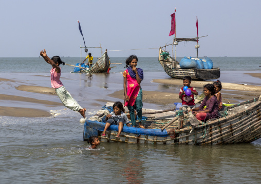 Bangladeshi children playing near moon fishing boats, Chittagong Division, Cox's Bazar Sadar, Bangladesh