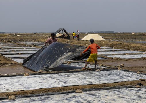 Bangladeshi men working in a salt field, Chittagong Division, Maheshkhali, Bangladesh