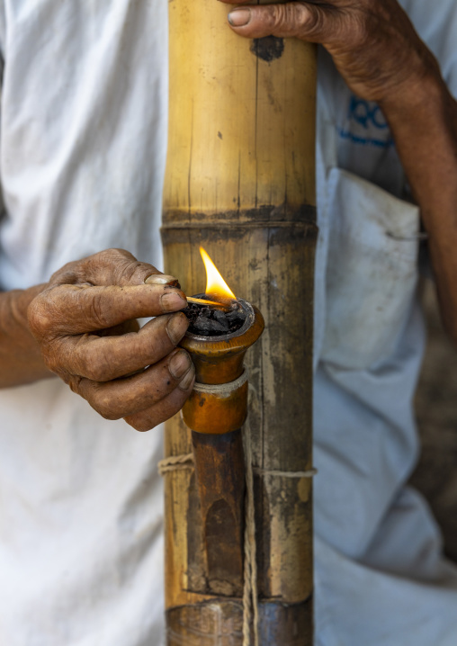 Chakma tribe man smoking bamboo pipe, Chittagong Division, Rangamati Sadar, Bangladesh