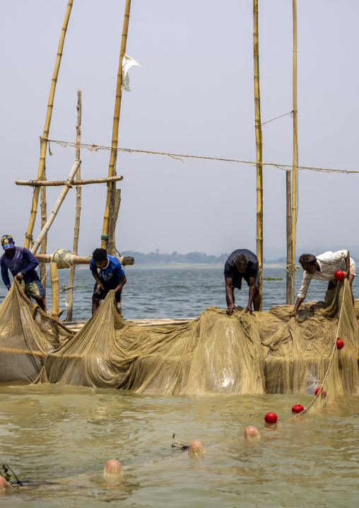 Bangladeshi fishermen pulling out fishing nets from Kaptai Lake, Chittagong Division, Rangamati Sadar, Bangladesh