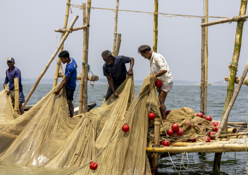 Bangladeshi fishermen pulling out fishing nets from Kaptai Lake, Chittagong Division, Rangamati Sadar, Bangladesh