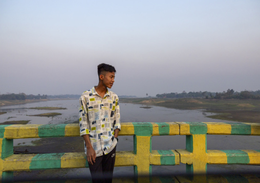 Bangladeshi teenage boy standing on Brazil bridge, Chittagong Division, Rangamati Sadar, Bangladesh