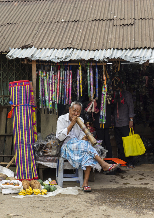 Chakma tribe man smoking bamboo pipe, Chittagong Division, Rangamati Sadar, Bangladesh