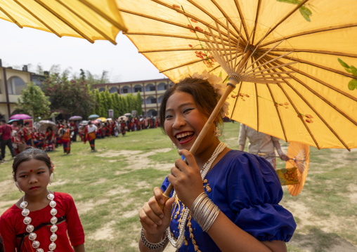 Chakma women with umbrellas in traditional clothing celebrating Biju festival, Chittagong Division, Kawkhali, Bangladesh