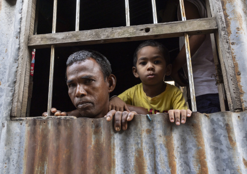 Portrait of a bangladeshi man with his son at a window, Dhaka Division, Munshiganj Sadar, Bangladesh