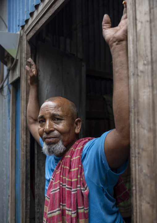 Portrait of a bangladeshi man stading at the entrance of his house, Dhaka Division, Munshiganj Sadar, Bangladesh