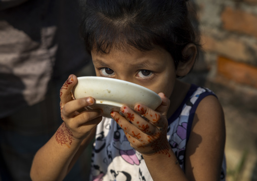 Bangladeshi girl drinking in a bowl, Dhaka Division, Munshiganj Sadar, Bangladesh