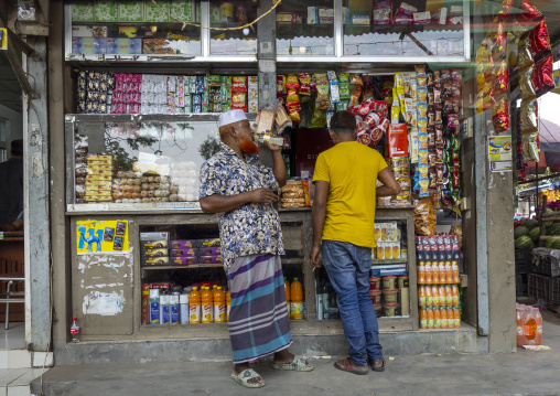 Bangladeshi man drinking in front of a shop, Dhaka Division, Tongibari, Bangladesh