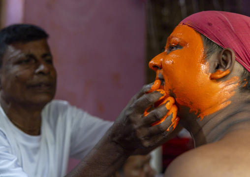 Make up of a Hindu devotee covered with orange color at Lal Kach festival, Dhaka Division, Munshiganj Sadar, Bangladesh