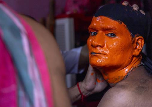 Make up of a Hindu devotee covered with orange color at Lal Kach festival, Dhaka Division, Munshiganj Sadar, Bangladesh