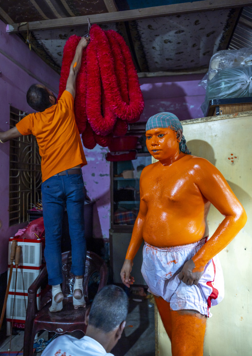 Portrait of a Hindu devotee covered with orange color in Lal Kach festival, Dhaka Division, Munshiganj Sadar, Bangladesh