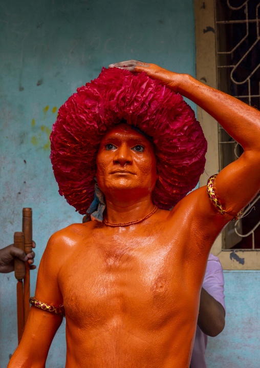 Portrait of a Hindu devotee covered with orange color in Lal Kach festival, Dhaka Division, Munshiganj Sadar, Bangladesh