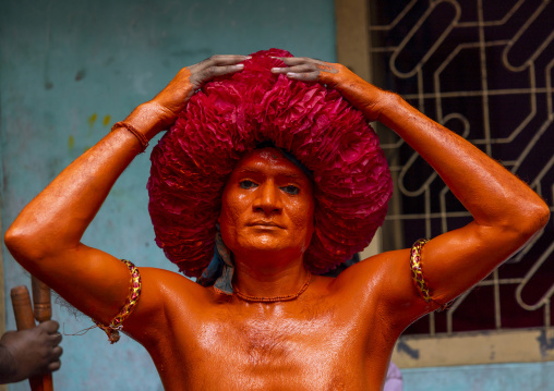 Portrait of a Hindu devotee covered with orange color in Lal Kach festival, Dhaka Division, Munshiganj Sadar, Bangladesh