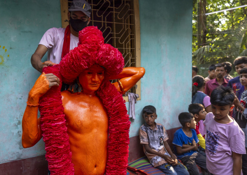 Portrait of a Hindu devotee covered with orange color in Lal Kach festival, Dhaka Division, Munshiganj Sadar, Bangladesh