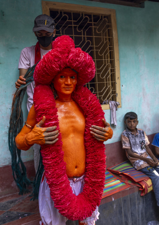 Portrait of a Hindu devotee covered with orange color in Lal Kach festival, Dhaka Division, Munshiganj Sadar, Bangladesh