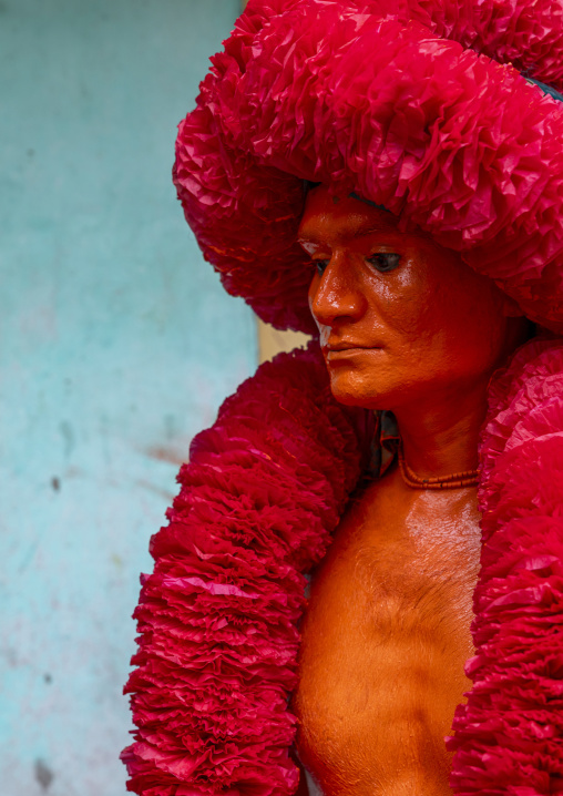 Portrait of a Hindu devotee covered with orange color in Lal Kach festival, Dhaka Division, Munshiganj Sadar, Bangladesh