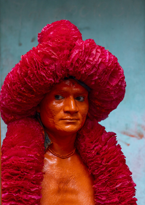 Portrait of a Hindu devotee covered with orange color in Lal Kach festival, Dhaka Division, Munshiganj Sadar, Bangladesh