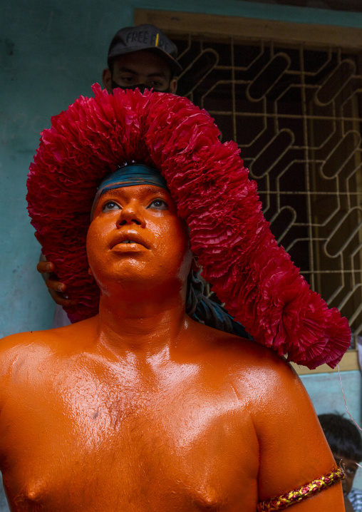 Portrait of a Hindu devotee covered with orange color in Lal Kach festival, Dhaka Division, Munshiganj Sadar, Bangladesh