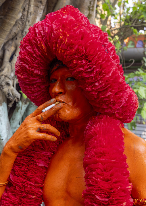 Portrait of a Hindu devotee covered with orange color in Lal Kach festival, Dhaka Division, Munshiganj Sadar, Bangladesh