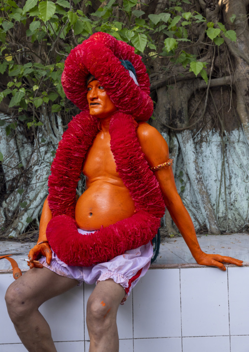 Portrait of a Hindu devotee covered with orange color in Lal Kach festival, Dhaka Division, Munshiganj Sadar, Bangladesh