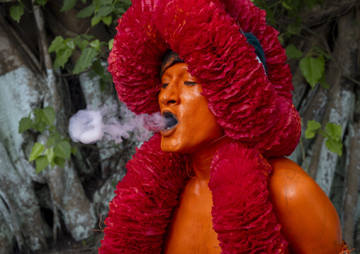 Portrait of a Hindu devotee covered with orange color in Lal Kach festival, Dhaka Division, Munshiganj Sadar, Bangladesh