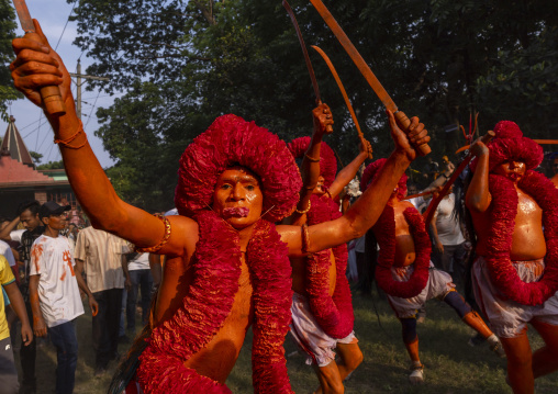 Hindu devotee with swords covered with orange color at Lal Kach festival, Dhaka Division, Munshiganj Sadar, Bangladesh