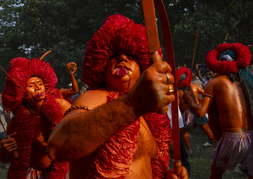 Hindu devotee with swords covered with orange color at Lal Kach festival, Dhaka Division, Munshiganj Sadar, Bangladesh