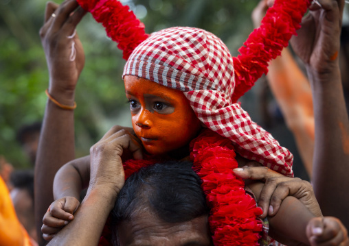 Hindu devotee boy covered with orange color in Lal Kach festival, Dhaka Division, Munshiganj Sadar, Bangladesh