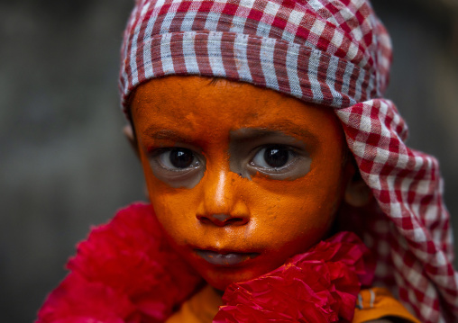 Hindu devotee boy covered with orange color in Lal Kach festival, Dhaka Division, Munshiganj Sadar, Bangladesh