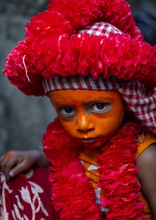 Hindu devotee boy covered with orange color in Lal Kach festival, Dhaka Division, Munshiganj Sadar, Bangladesh