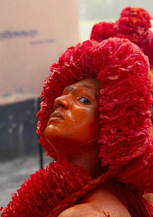 Portrait of a Hindu devotee covered with orange color in Lal Kach festival, Dhaka Division, Munshiganj Sadar, Bangladesh