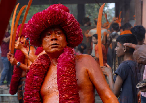 Portrait of a Hindu devotee covered with orange color in Lal Kach festival, Dhaka Division, Munshiganj Sadar, Bangladesh