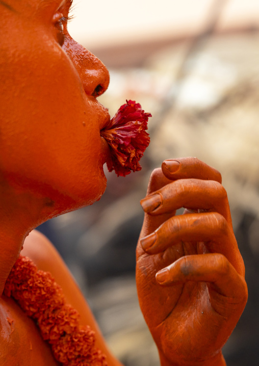 Portrait of a Hindu devotee covered with orange color in Lal Kach festival, Dhaka Division, Munshiganj Sadar, Bangladesh