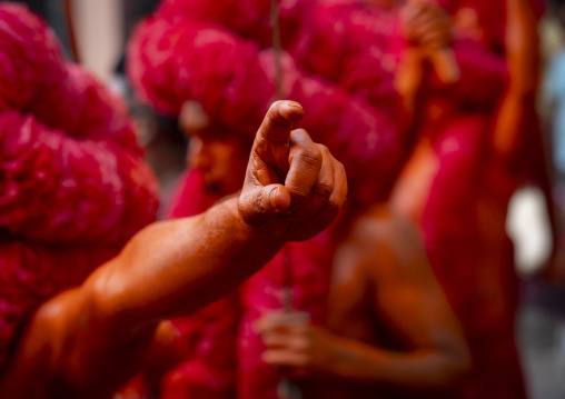 Hand of a Hindu devotee covered with orange color at Lal Kach festival, Dhaka Division, Munshiganj Sadar, Bangladesh