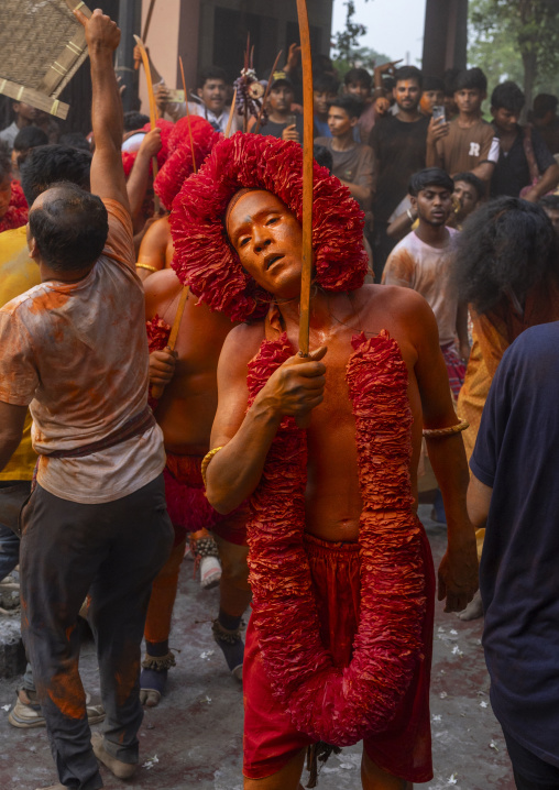 Portrait of a Hindu devotee covered with orange color in Lal Kach festival, Dhaka Division, Munshiganj Sadar, Bangladesh